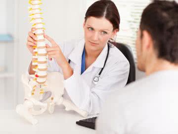 A female doctor running a successful practice with chiropractic funding
