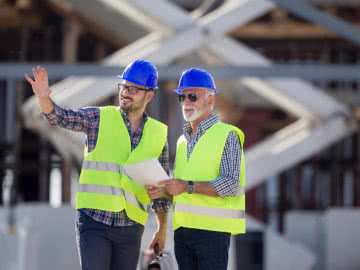 Consultant gives small business advice to a construction company owner