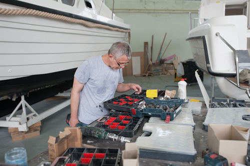 boat worker is looking for his corresponding tool 