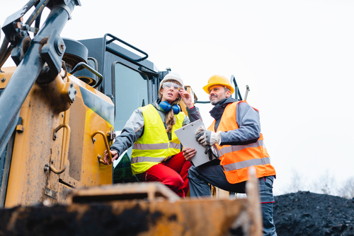 Construction workers use new equipment, bought using the Section 179 deduction.