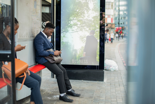 Business people waiting at a bus stop