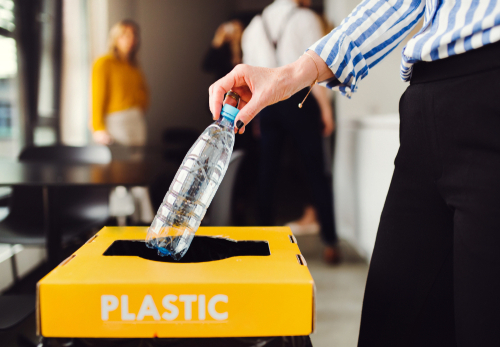 Waste separation and recycling in business office, a midsection.